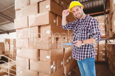 Composite image of happy repairman wearing hard hat while holdin