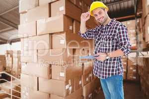 Composite image of happy repairman wearing hard hat while holdin