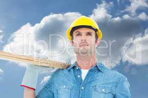 Composite image of worker carrying wooden planks