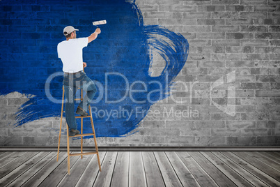 Composite image of man on ladder painting with roller