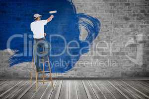 Composite image of man on ladder painting with roller