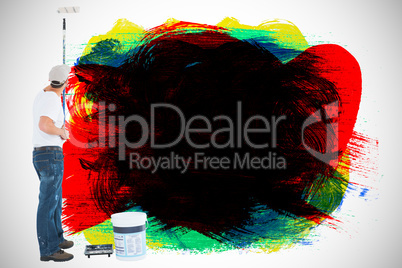 Composite image of man using paint roller on white background