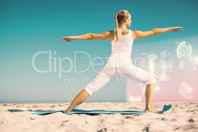 Composite image of calm woman standing in warrior pose on beach