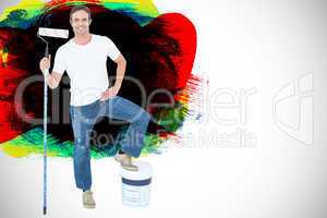 Composite image of man with paint bucket and roller on white bac