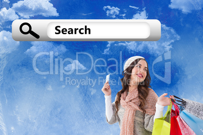 Composite image of beauty brunette holding credit card and shopp