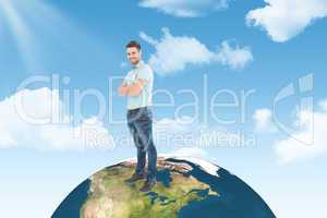 Composite image of smiling young delivery man standing arms cros