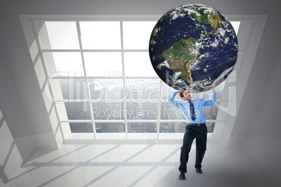 Composite image of businessman carrying the world