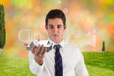 Composite image of businessman standing with hand out