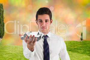 Composite image of businessman standing with hand out