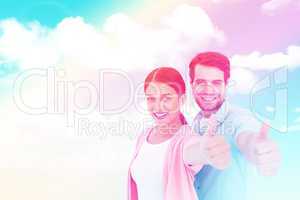 Composite image of happy couple showing thumbs up