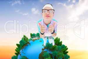 Composite image of smiling geeky hipster looking at camera thumb