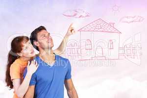 Composite image of happy couple looking upwards