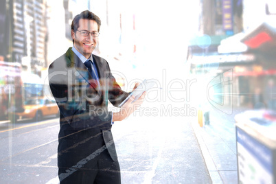 Composite image of businessman looking at the camera while using