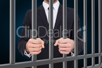 Composite image of elegant businessman in suit clenching his fis