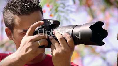 Man taking photo, amateur photographer shooting picture in park