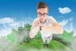 Composite image of geeky hipster pointing to his watch