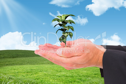 Composite image of businessman holding his hands out