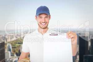 Composite image of happy delivery man holding cardboard box and