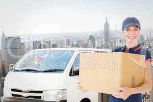 Composite image of happy delivery woman holding cardboard box