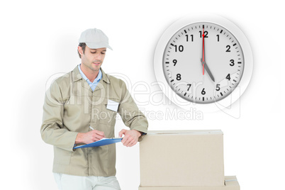 Composite image of delivery man writing on clipboard