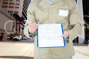 Composite image of delivery man showing blank paper on clipboard