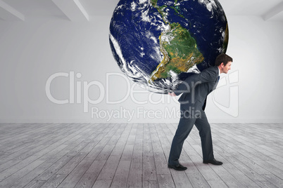 Composite image of businessman carrying the world