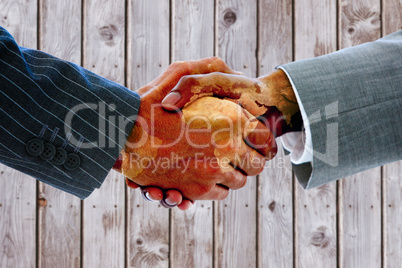 Composite image of business people shaking hands