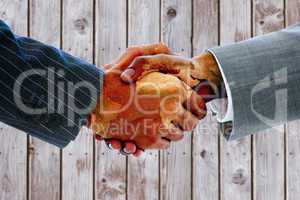 Composite image of business people shaking hands