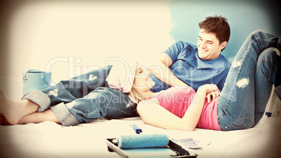 Happy couple relaxing after painting a room