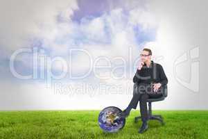 Composite image of thoughtful businessman sitting on a swivel ch