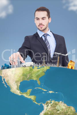 Composite image of cheerful businessman pointing at camera