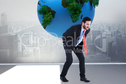 Composite image of businessman carrying the world