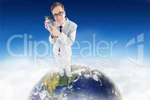 Composite image of geeky smiling businessman showing calculator