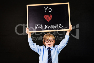 Composite image of cute pupil holding chalkboard