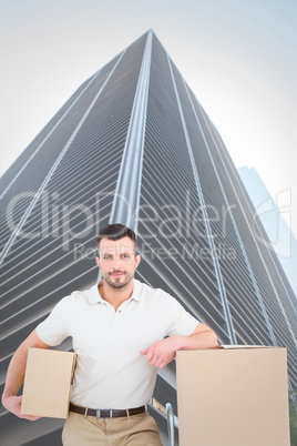 Composite image of delivery man with trolley of boxes