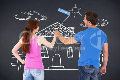 Composite image of couple painting a wall together