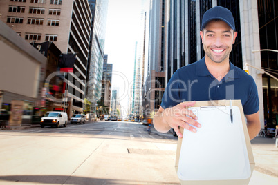 Composite image of happy delivery man with package and clipboard