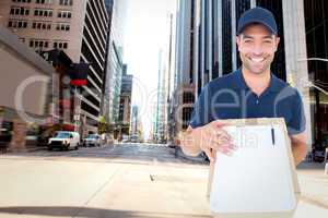 Composite image of happy delivery man with package and clipboard