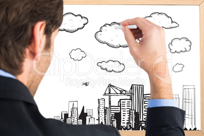 Composite image of businessman writing with a white chalk