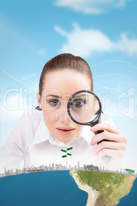 Composite image of businesswoman typing and looking through magn