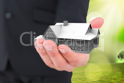 Composite image of businessman holding out his hand