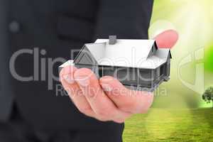 Composite image of businessman holding out his hand