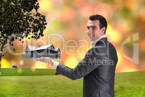 Composite image of businessman presenting with hand