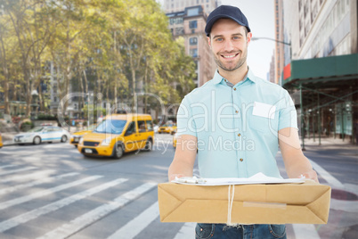 Composite image of handsome courier man with parcel