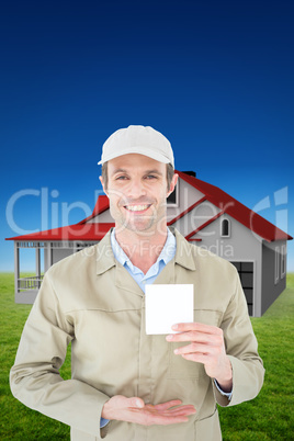Composite image of happy delivery man showing blank note
