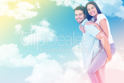 Composite image of happy casual man giving pretty girlfriend pig