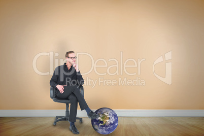 Composite image of thoughtful businessman sitting on a swivel ch