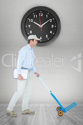 Composite image of delivery man pushing empty trolley