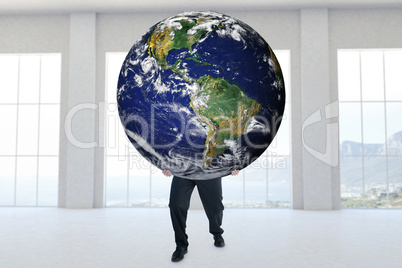 Composite image of businessman carrying the world