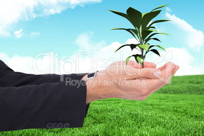 Composite image of businessman with arms out presenting something